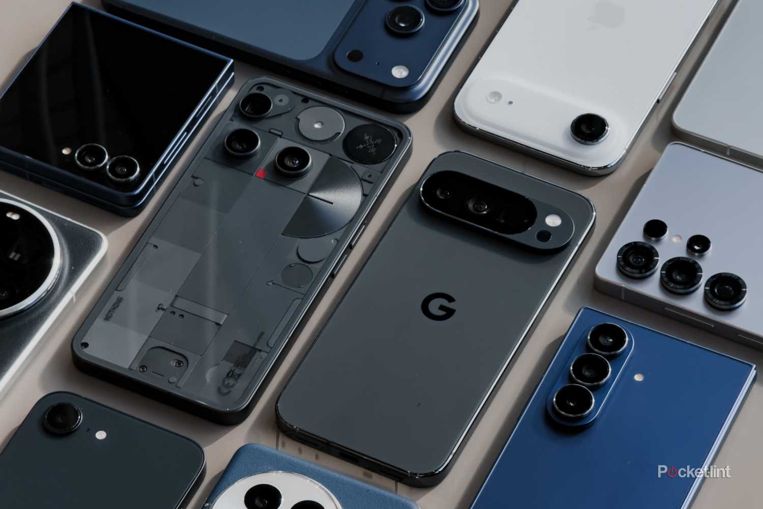 A collection of 2025 flagship phones on a grey table (angled)-1
