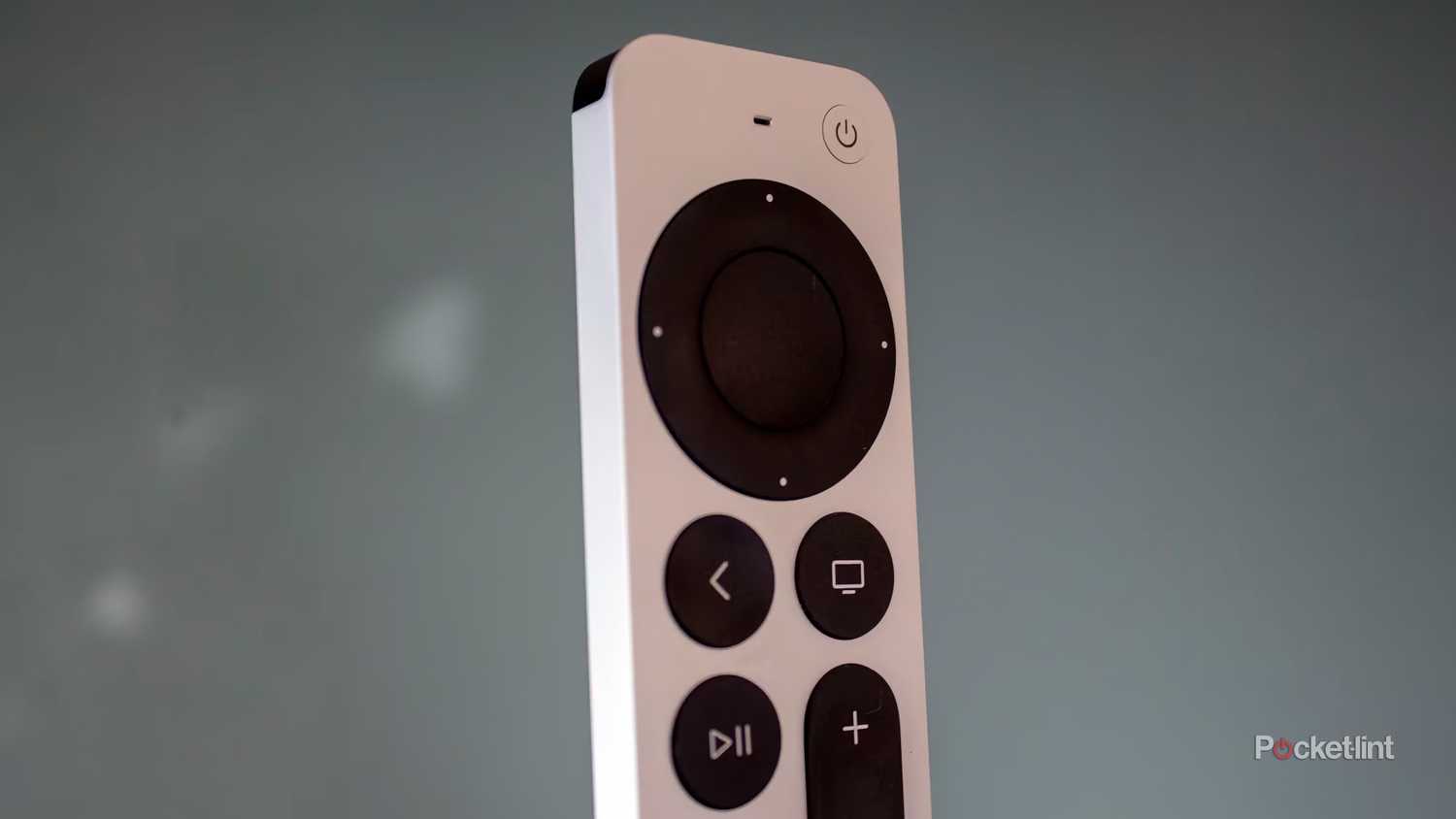 The top half of a Siri Remote, with touchpad and back button visible.