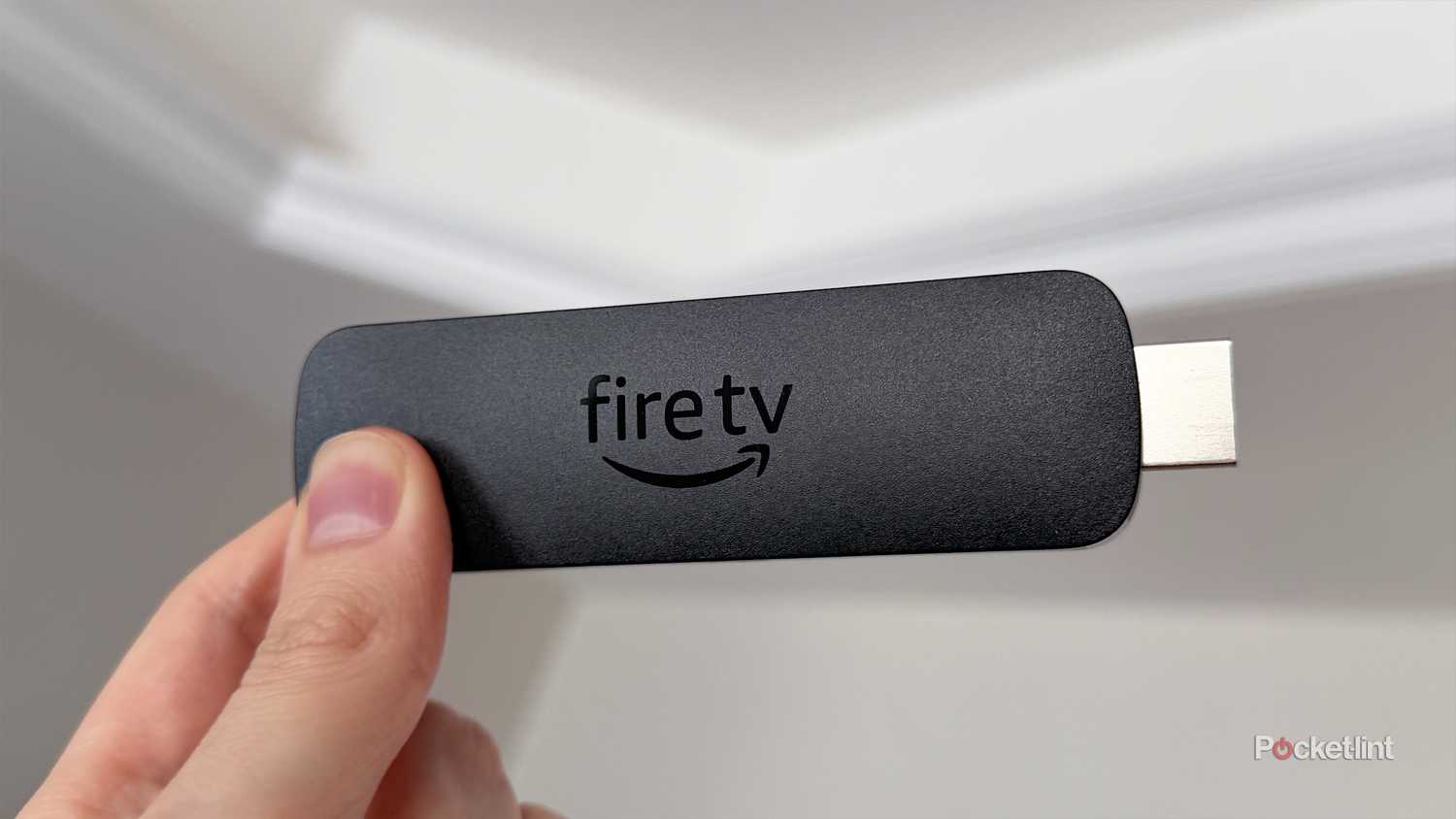 Person holding Fire TV Stick 4K Max.