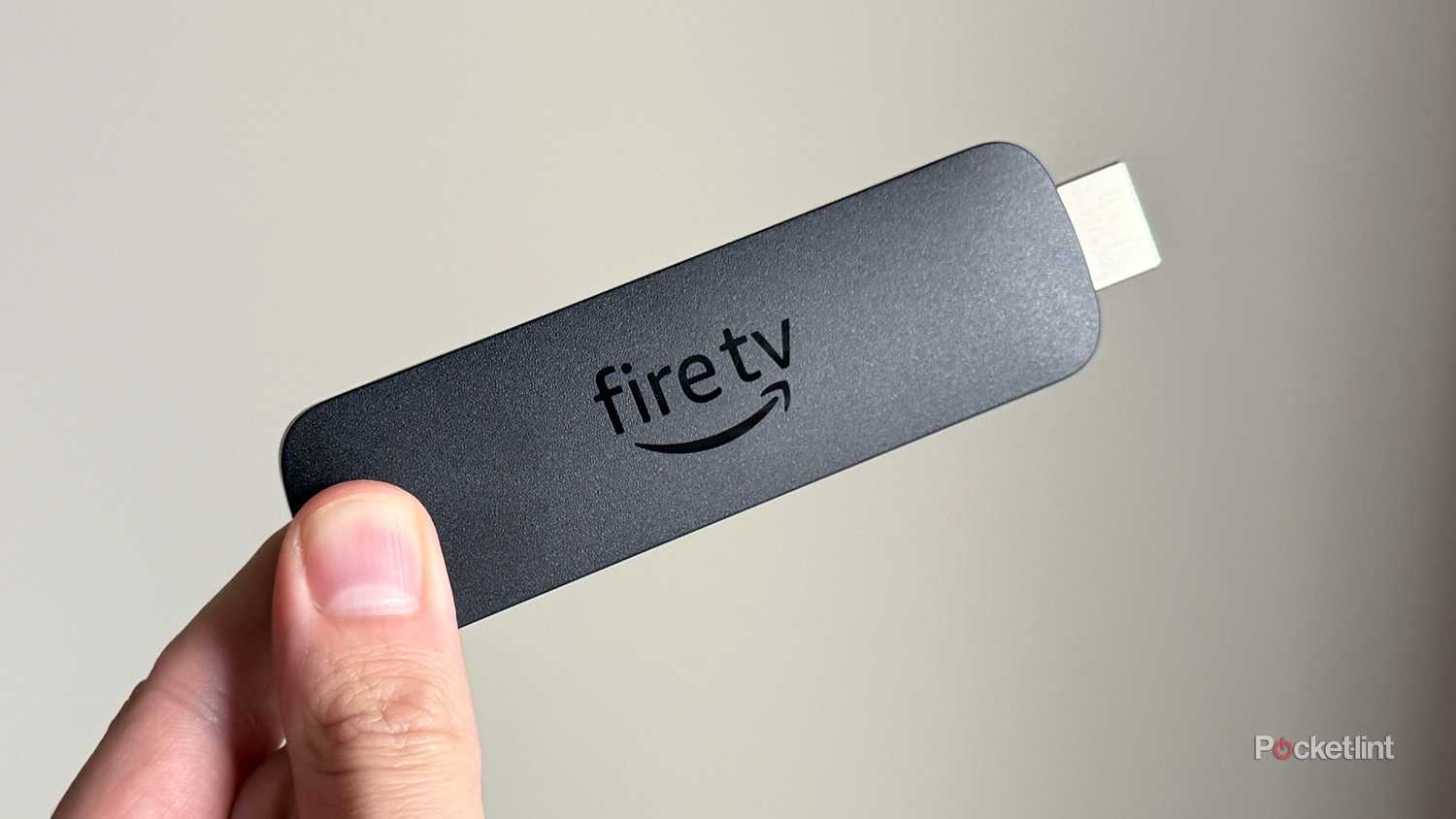 Person holding Fire TV Stick 4K Max.