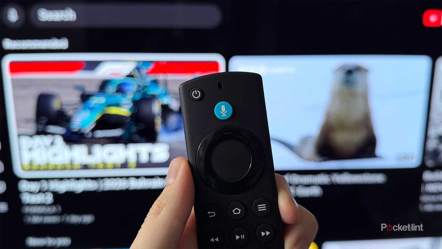 Person holding remote in front of TV with YouTube on it.