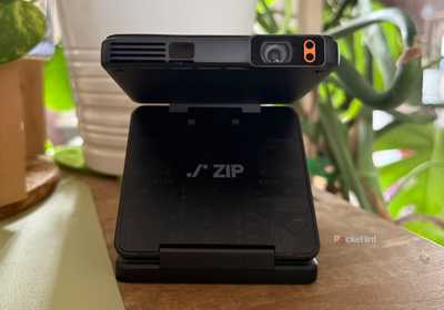 Aurzen Zip Projector unfolded in front of plants.