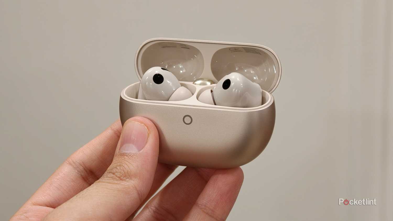 Huawei FreeBuds Pro 5 in hand with case lid open