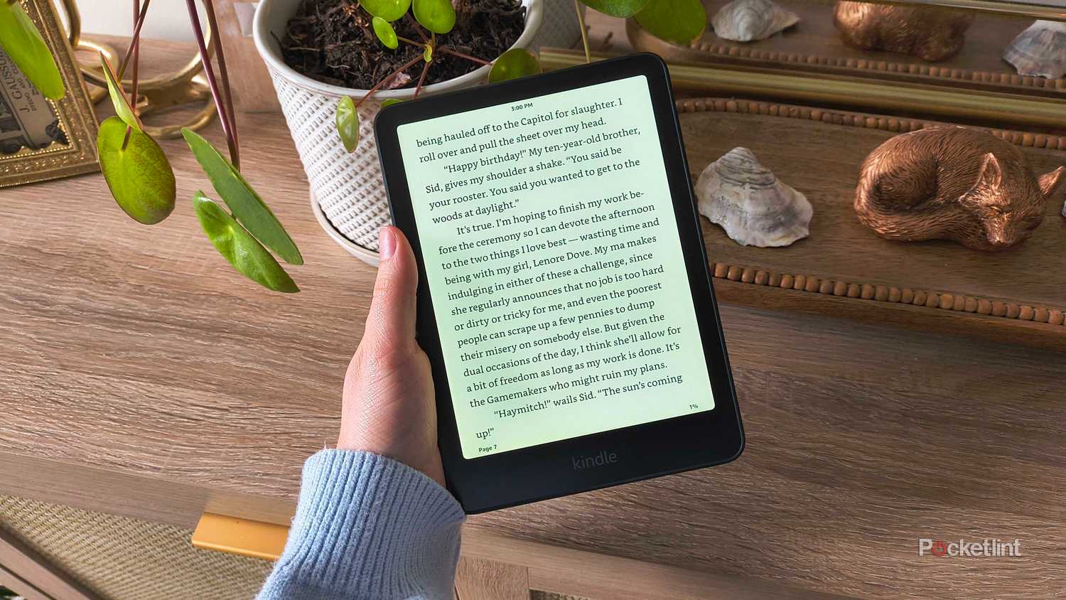 Holding a 2024 Kindle Paperwhite. 