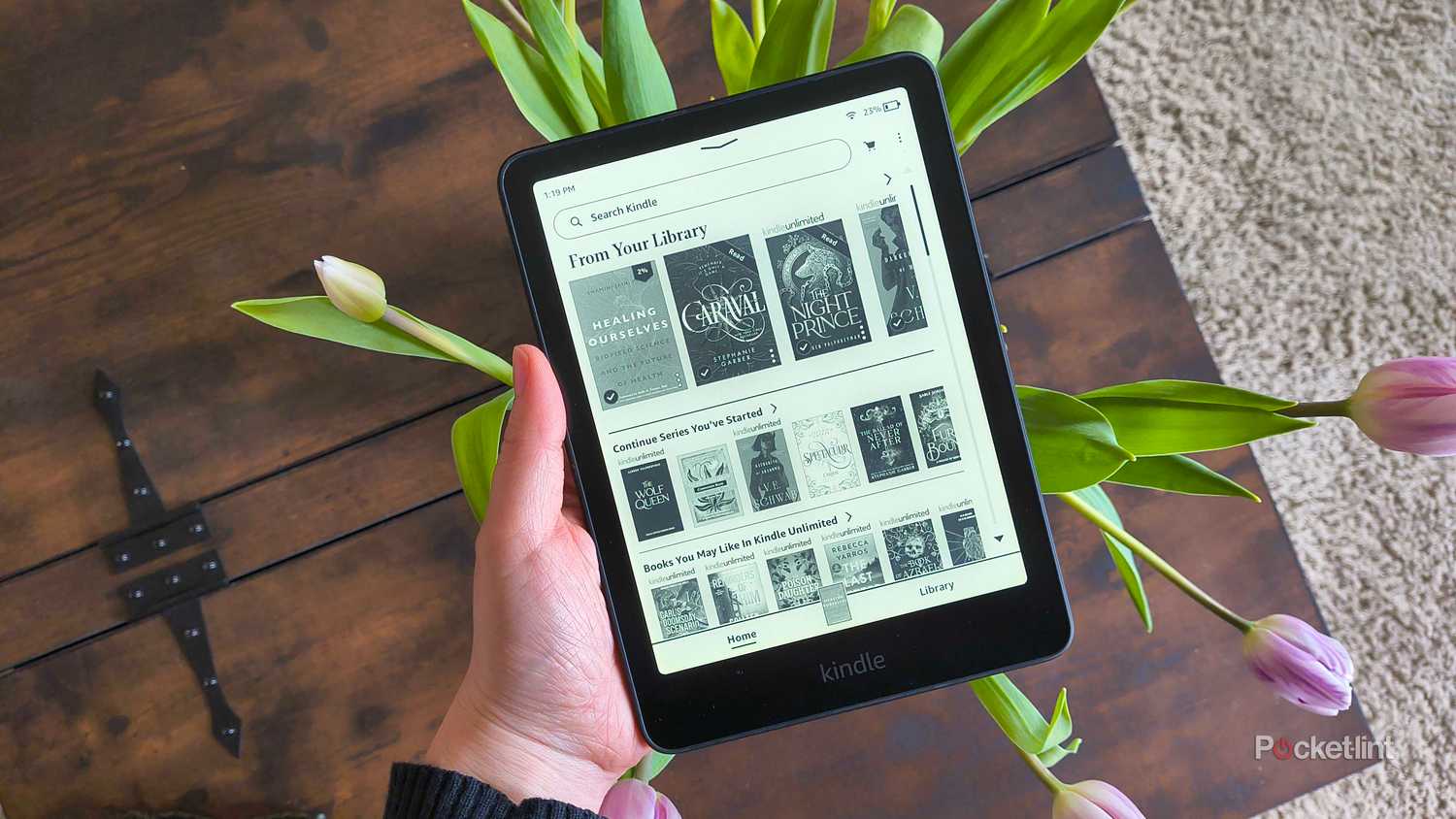 A Kindle over tulips.