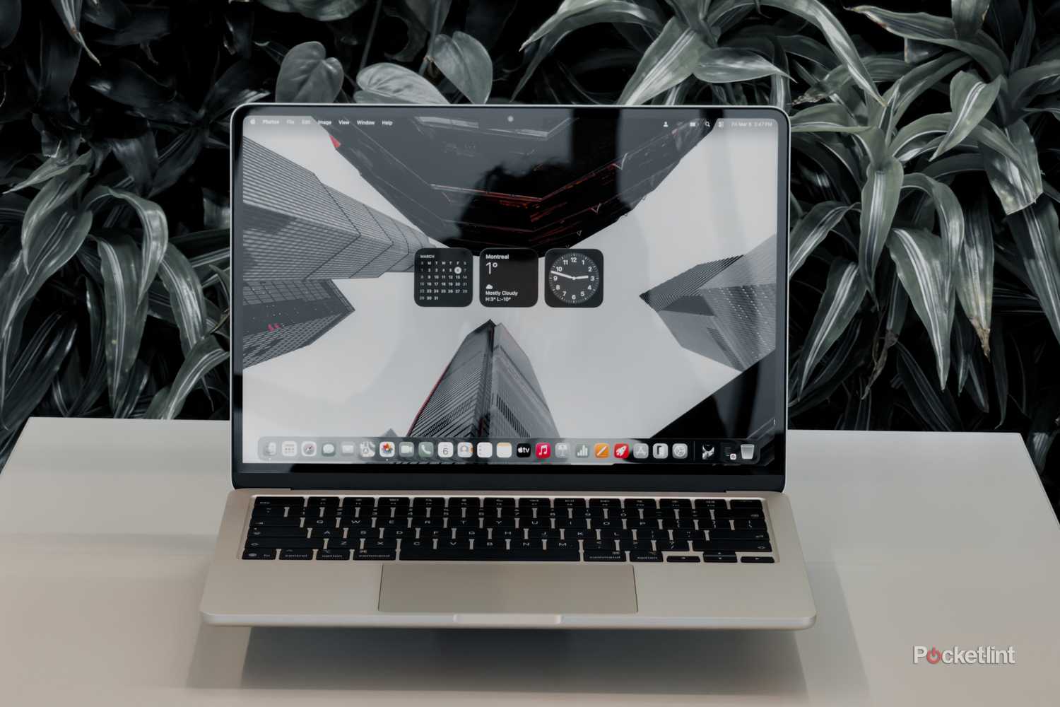 MacBook Air with M5 floating on a white table head on with screen on