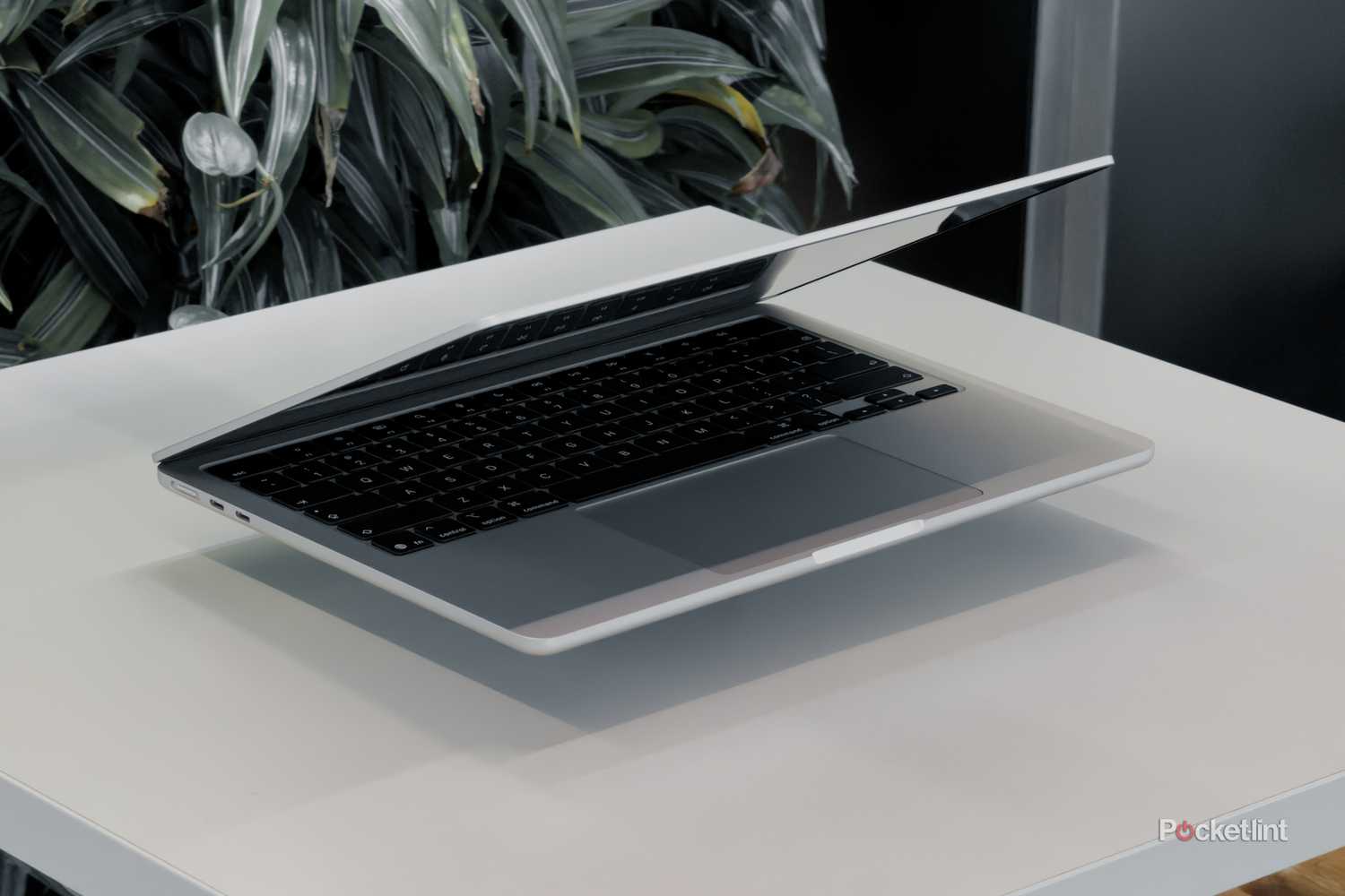 MacBook Air with M5 floating on a white table with screen facing down