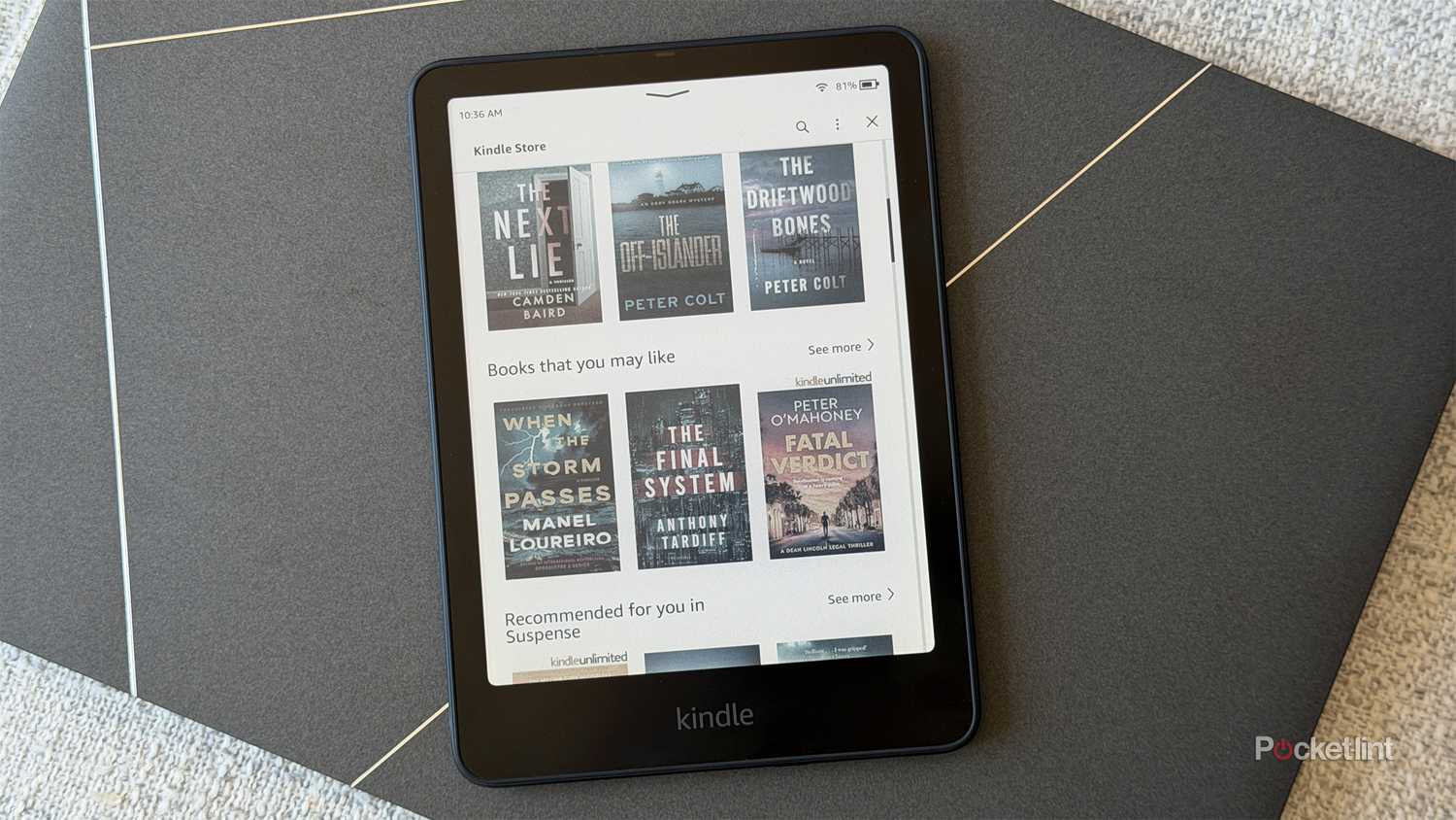 Kindle Colorsoft sitting on top of a Windows laptop.