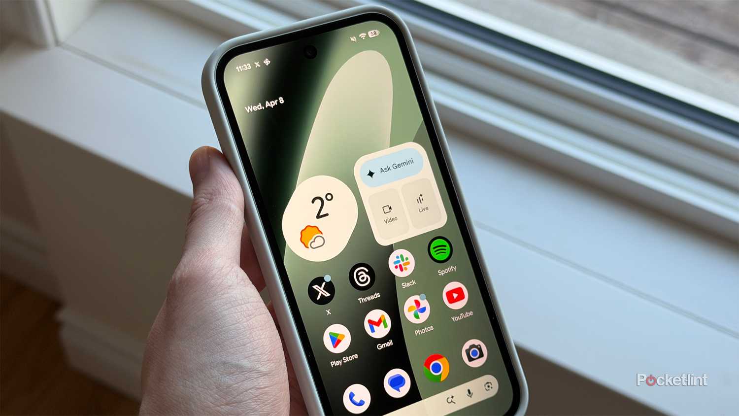 Person holding Pixel 10a smartphone.