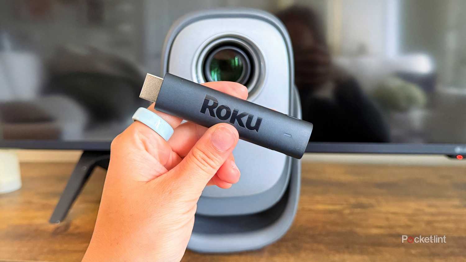 Roku streaming stick in front of a projector. 