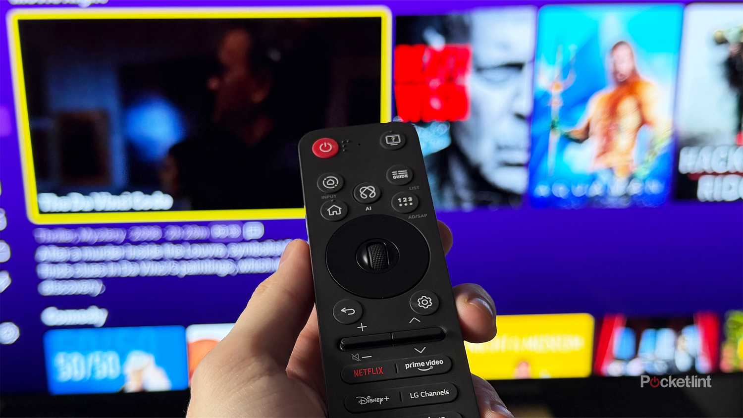 Person holding remote in front of TV with Tubi on it.