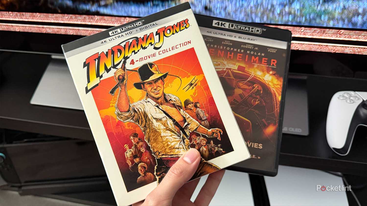 Person holding 4K Ultra HD Blu-rays.
