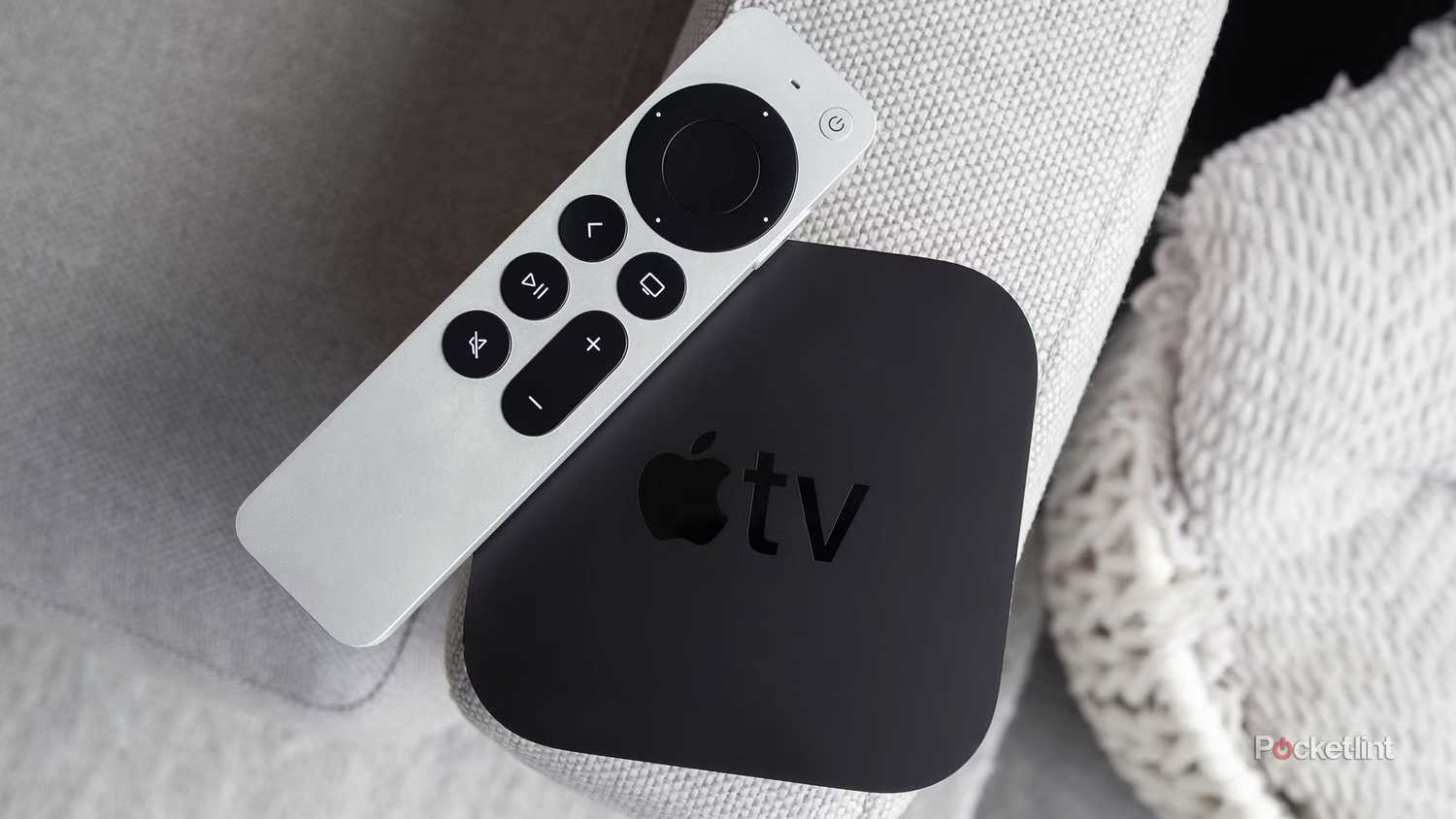 An Apple TV 4K on a couch.