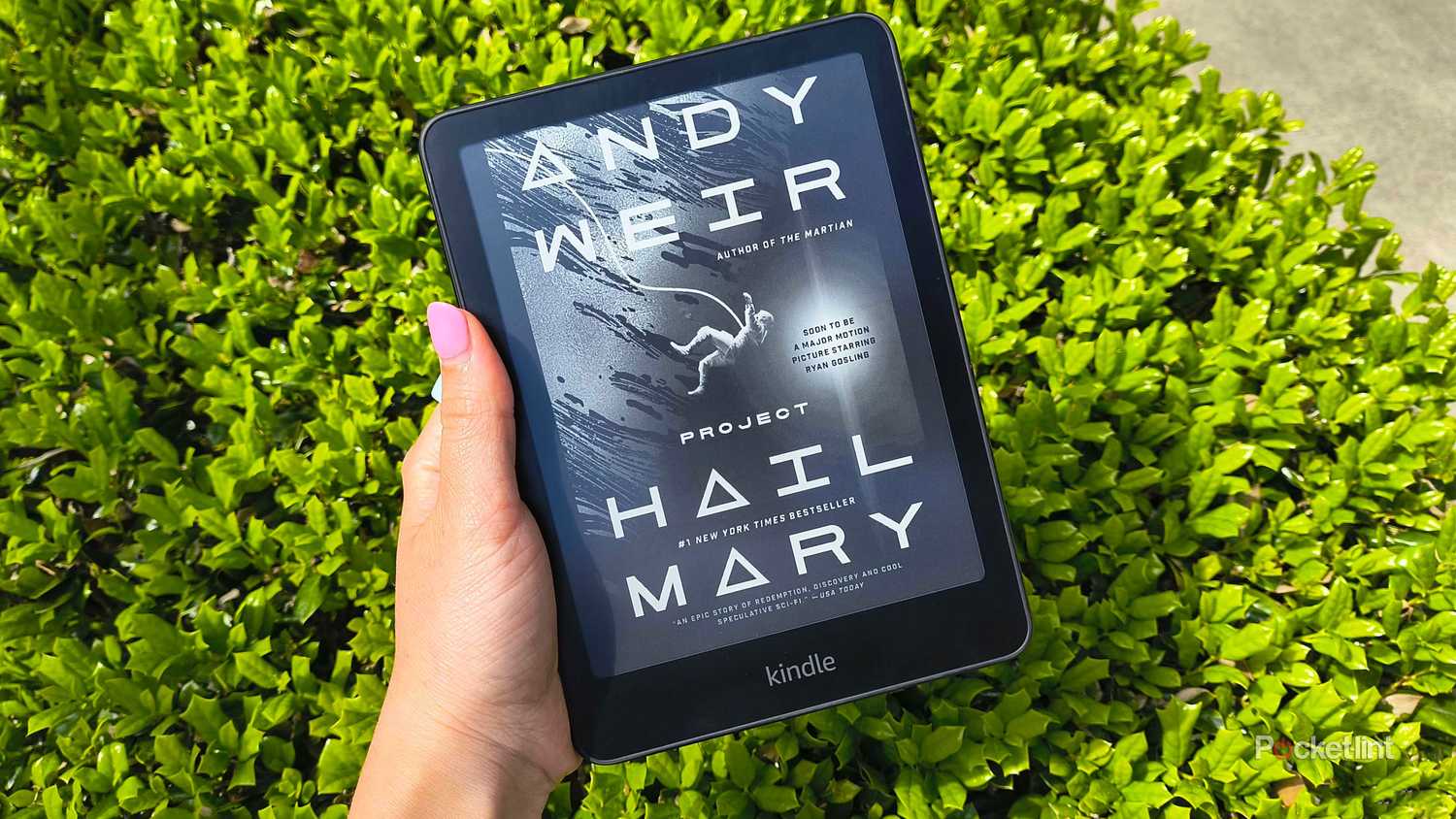 Person holding Kindle e-reader.