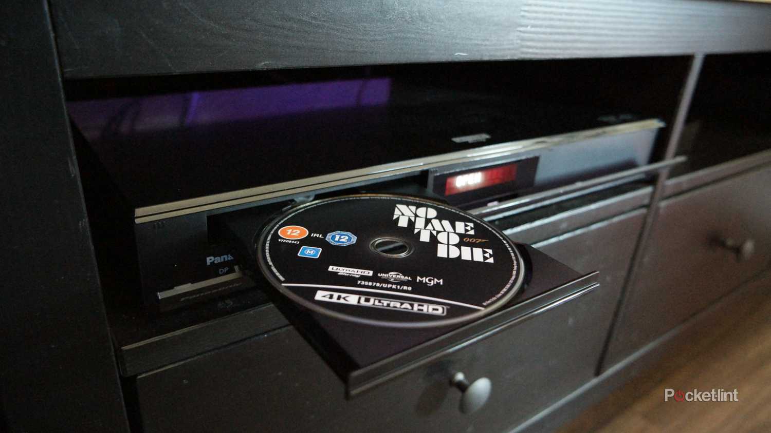 Panasonic UB820-K with the tray open and a Blu-ray in it. "No Time To Die" can be seen in the tray.