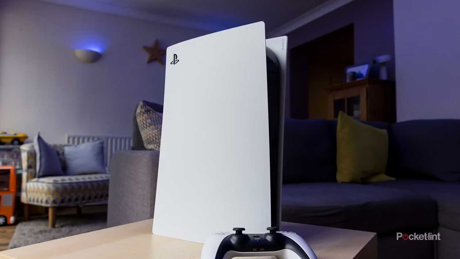 A PlayStation 5 on a table with its DualSense controller.