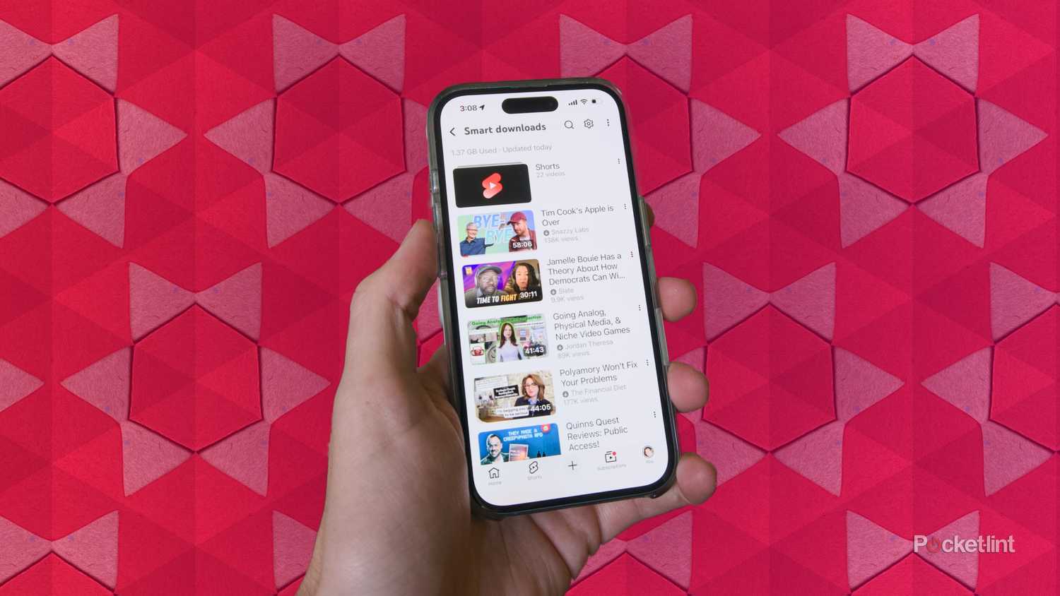 An iPhone 16 displaying the Smart Downloads section of the YouTube app.