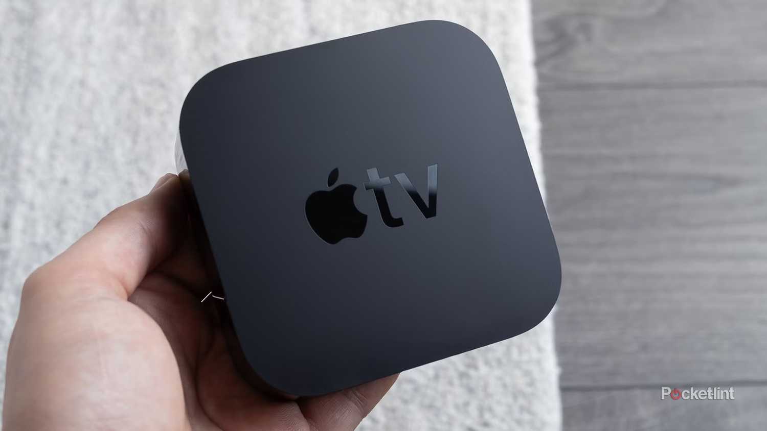 Person holding an Apple TV 4K.