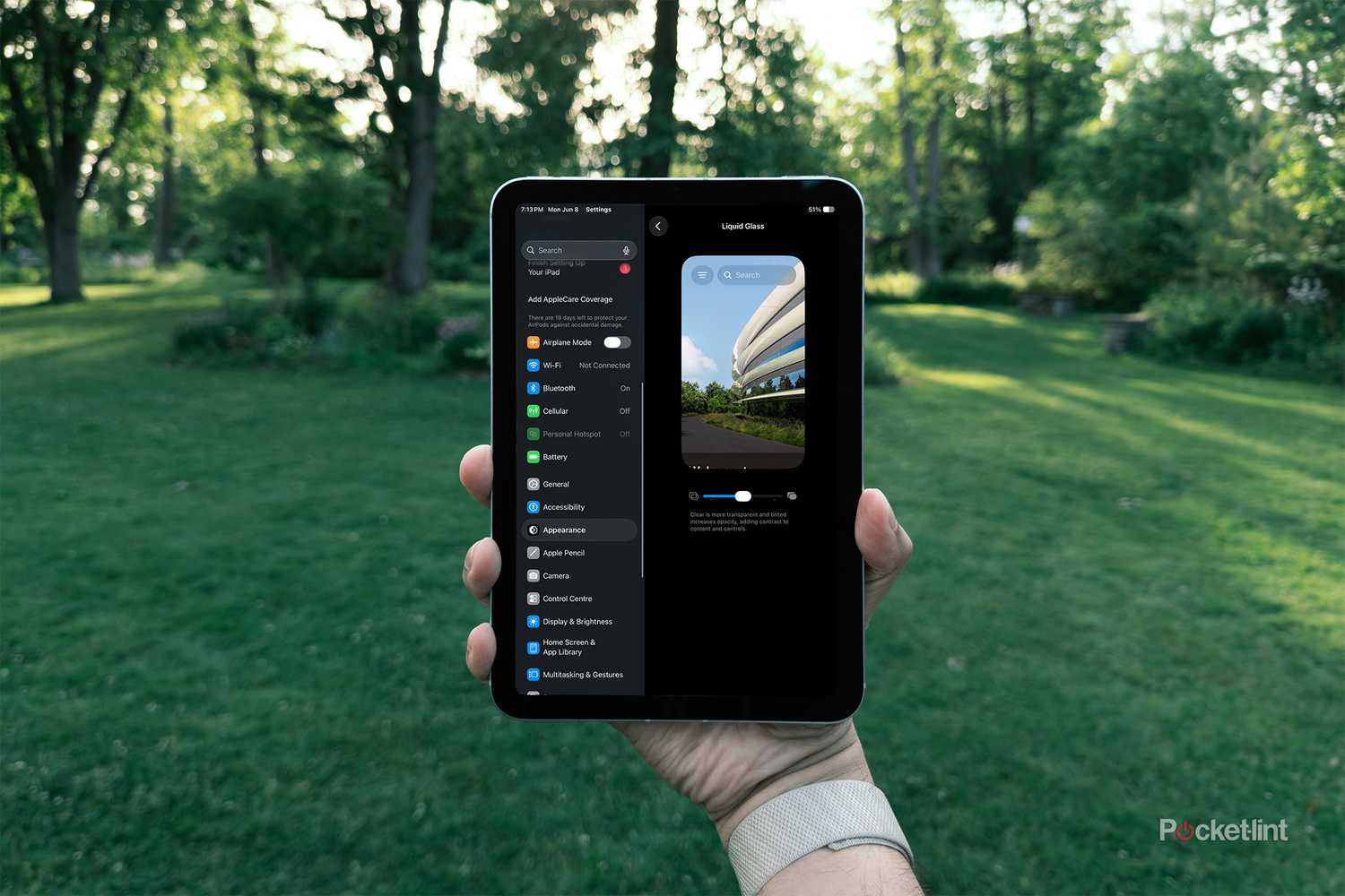 iPadOS 27 Liquid Glass Adjustment setting on iPad Mini in hand against grassy background