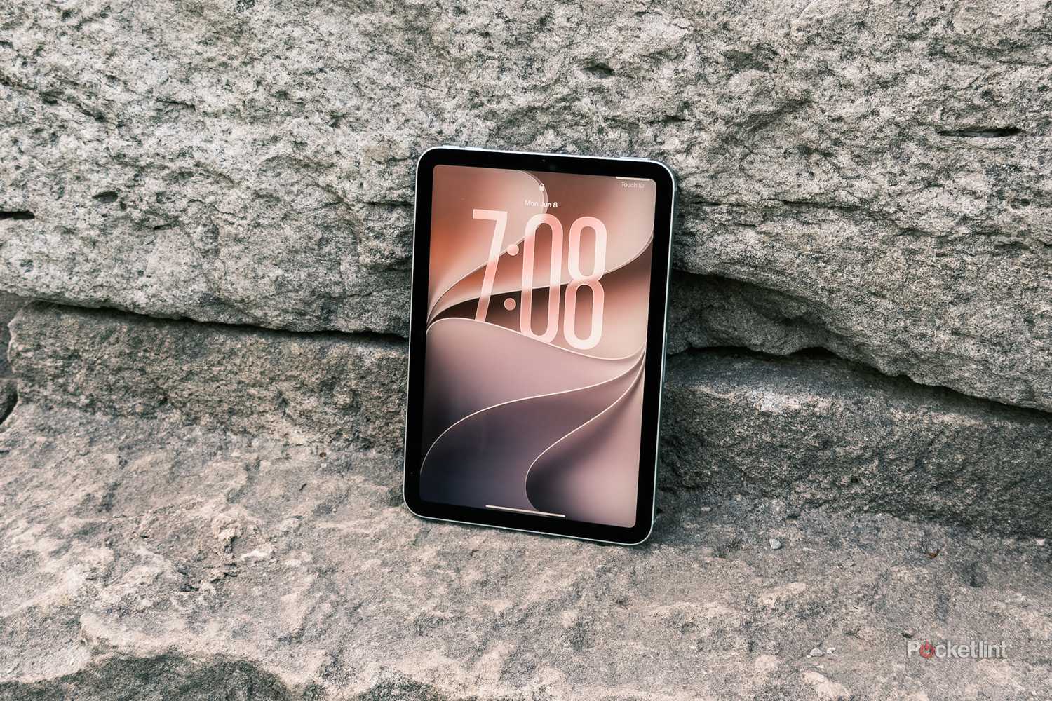 iPadOS 27 lockscreen on iPad Mini on a rocky background