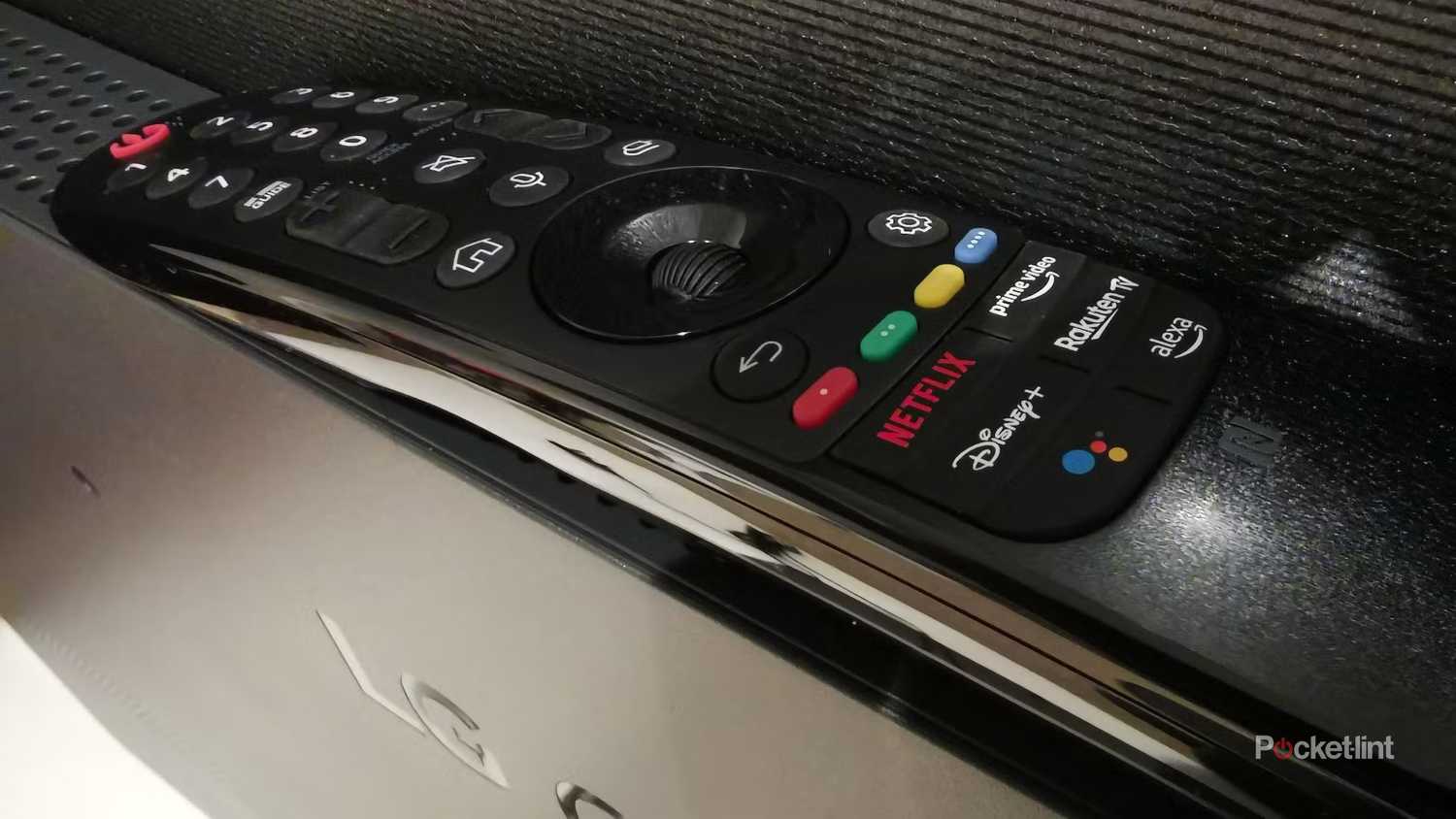 An older generation LG Magic Remote sitting on top of an LG TV.