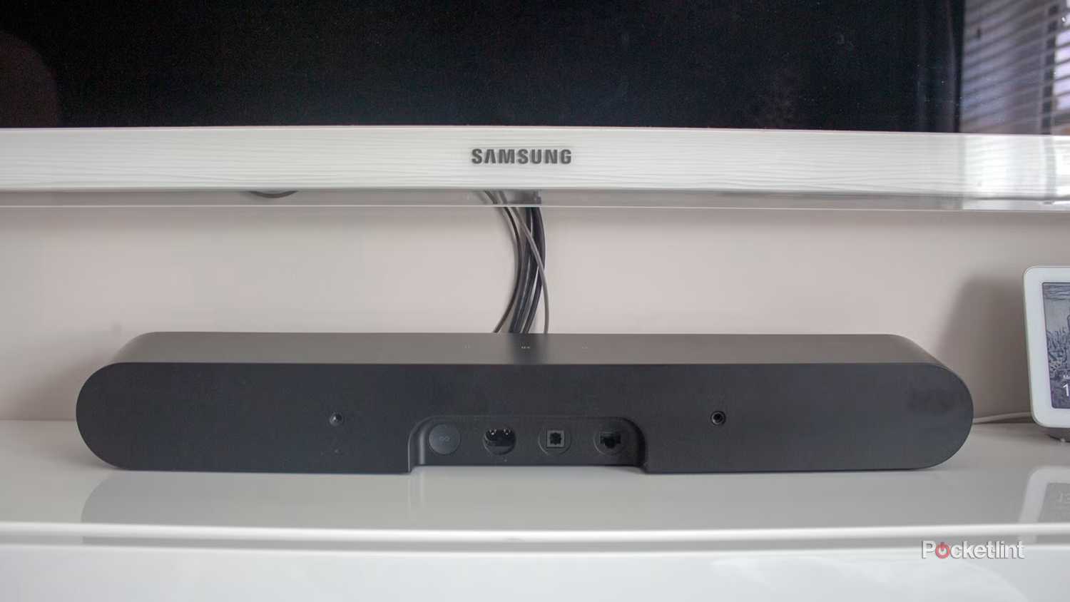 The back ports on a Sonos Ray underneath a white TV.