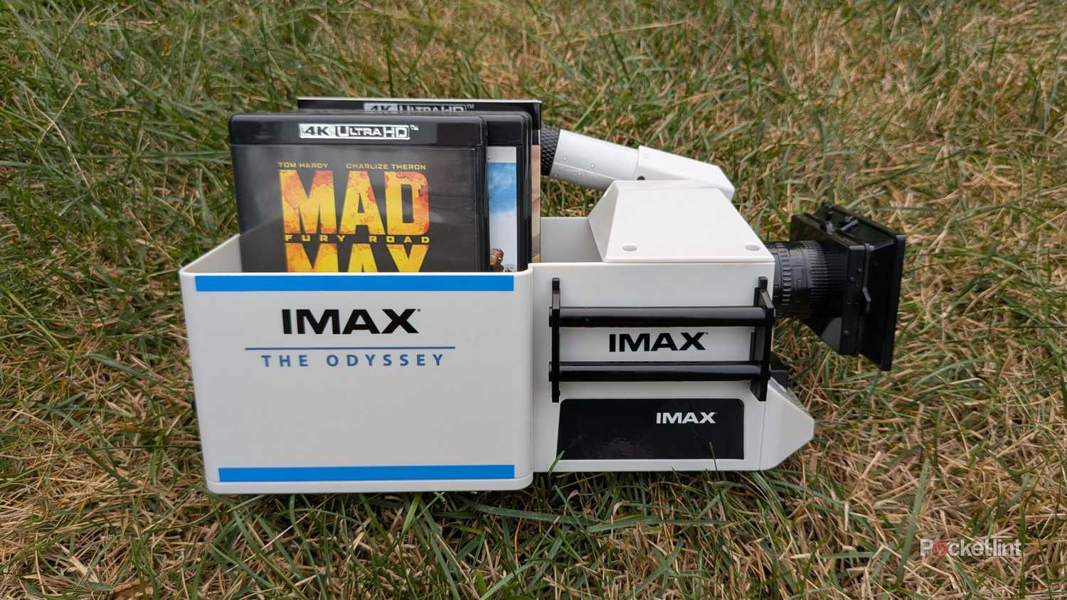 A bunch of 4K Blu-rays in an IMAX camera popcorn bucket.