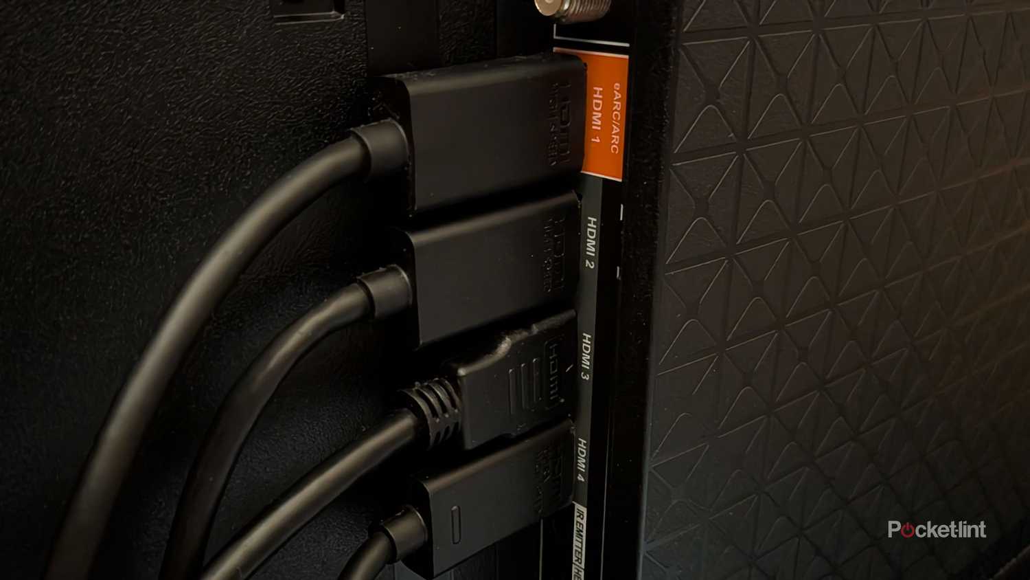 Four HDMI cables plugged into a TV.