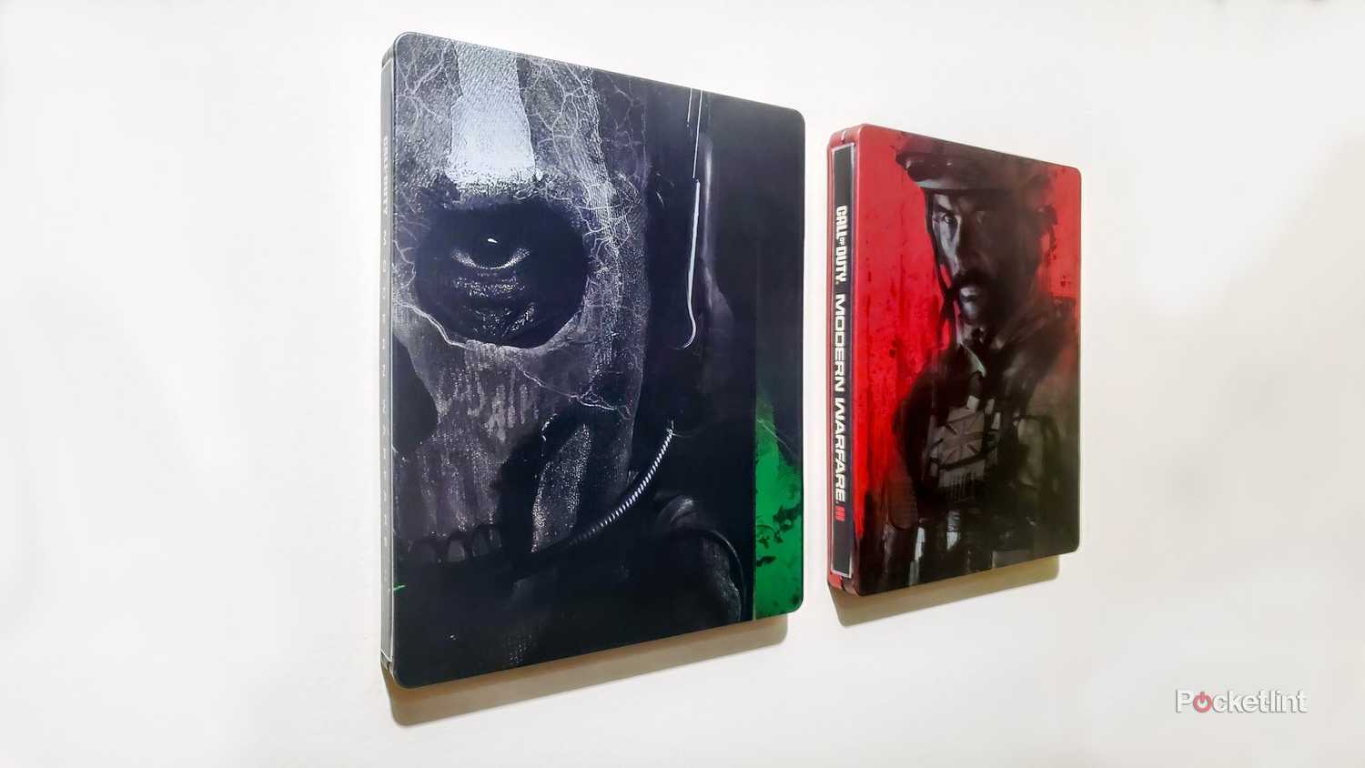 Call of Duty Modern Warfare 2 and Modern Warfare 3 steelbooks magnetized to wall