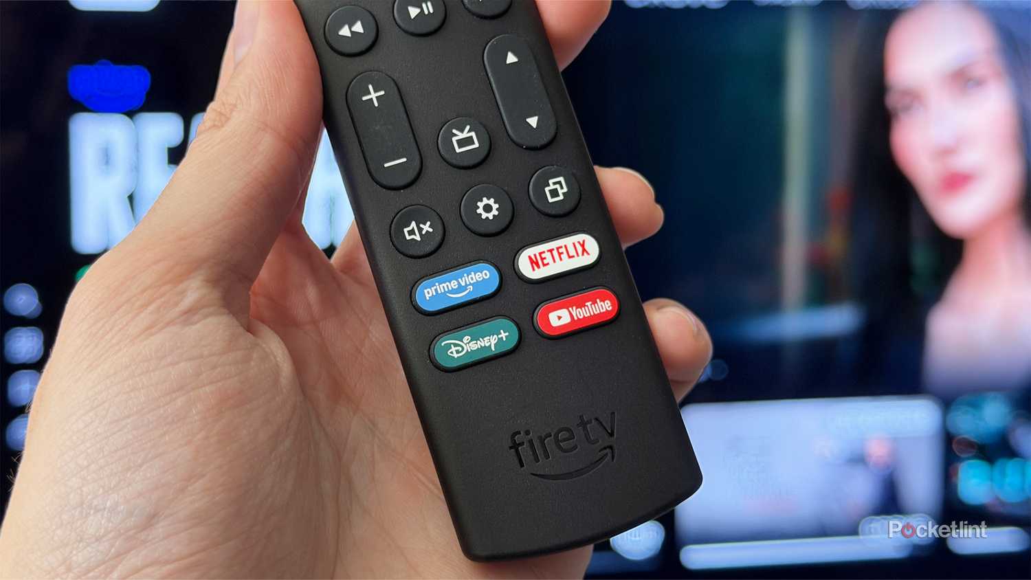 Person holding Fire TV remote with Netflix and Prime Video buttons.