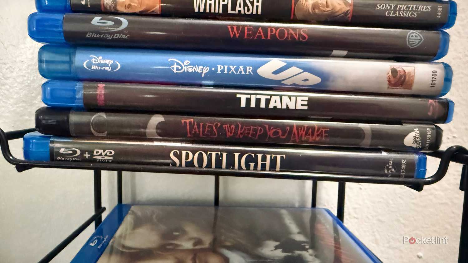 Several Blu-rays on display rack.