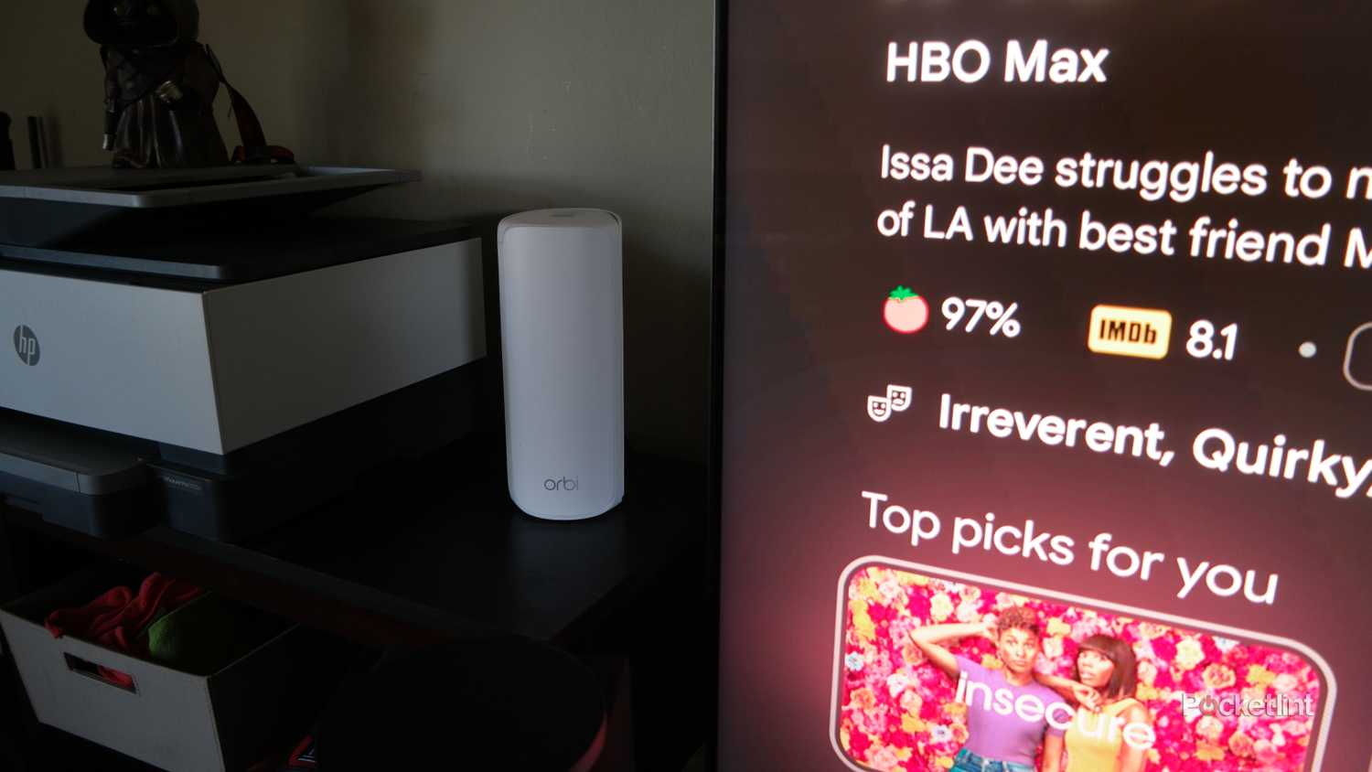 The Orbi 770 in a living room next to a large TV and soundbar