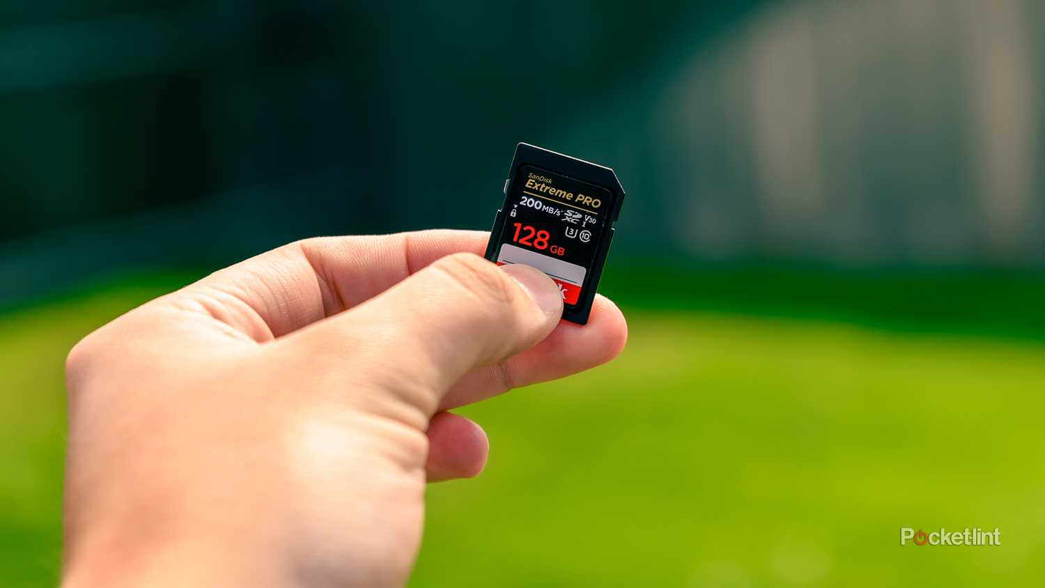 A still photo of someone holding a SanDisk MircoSD card.
