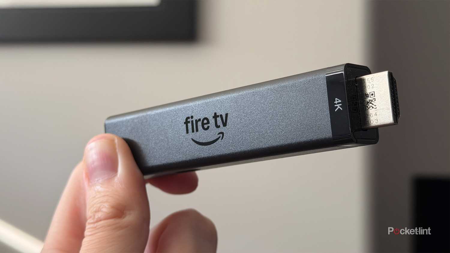 Person holding Fire TV Stick 4K.