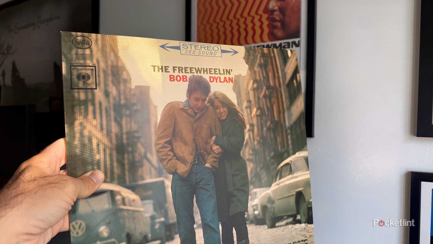 Bob Dylan album with Cool Hand Luke poster in background.