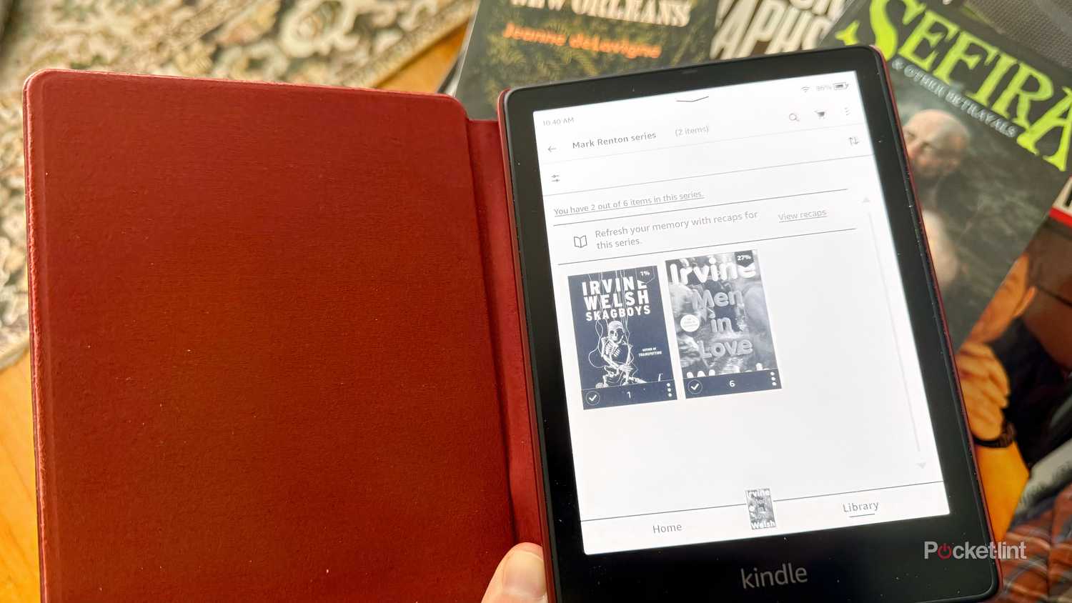 Kindle in front of paper books.
