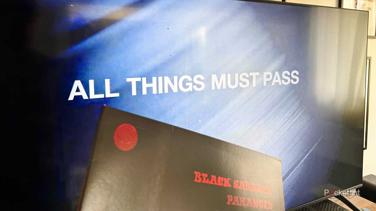All Things Must Pass documentary on TV screen with Black Sabbath album in front.