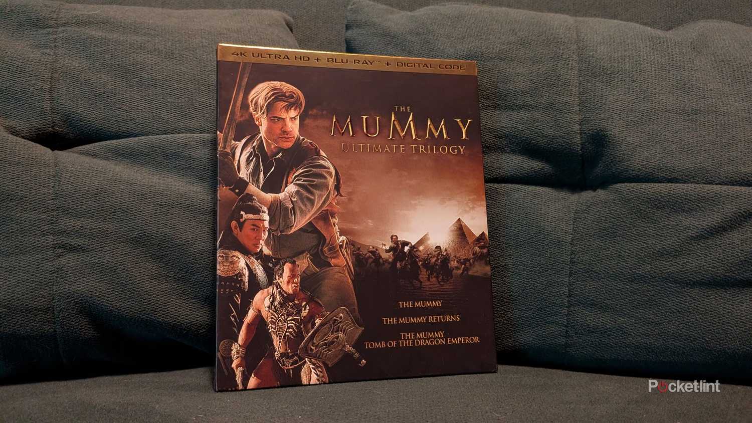The Mummy Ultimate Trilogy box set on a couch.
