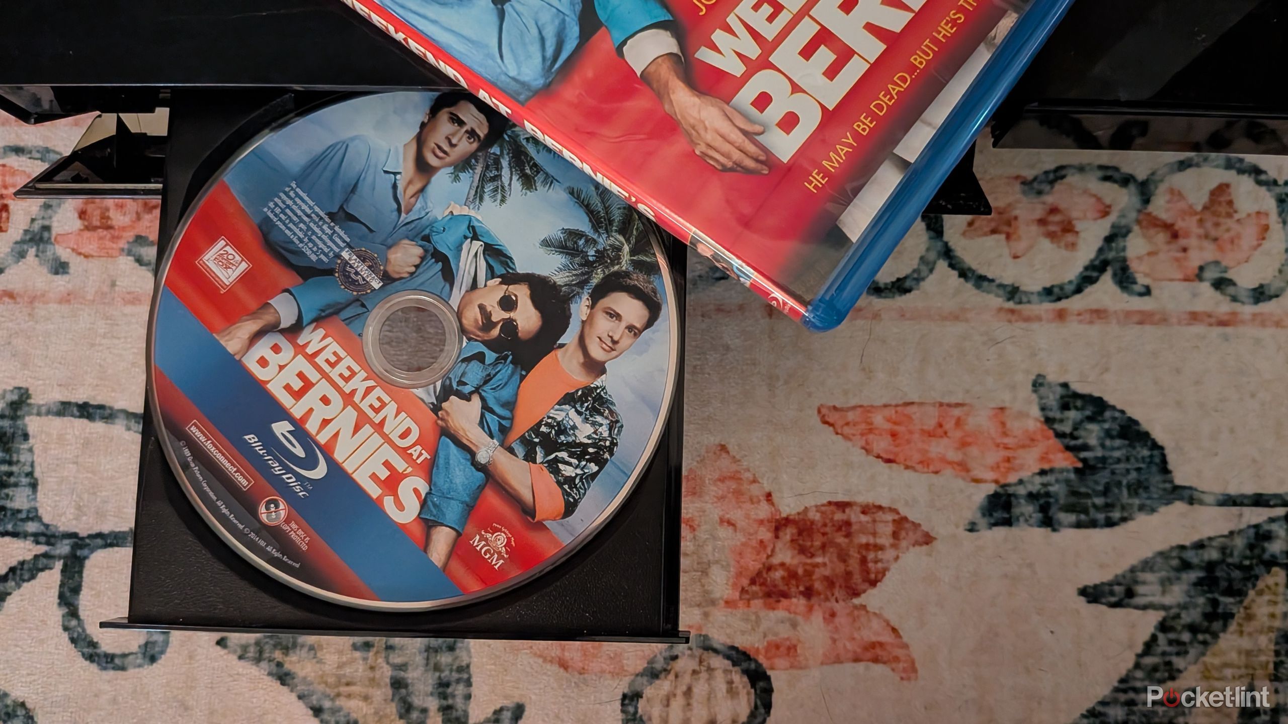 A Weekend at Bernie's Blu-ray in a disc tray.