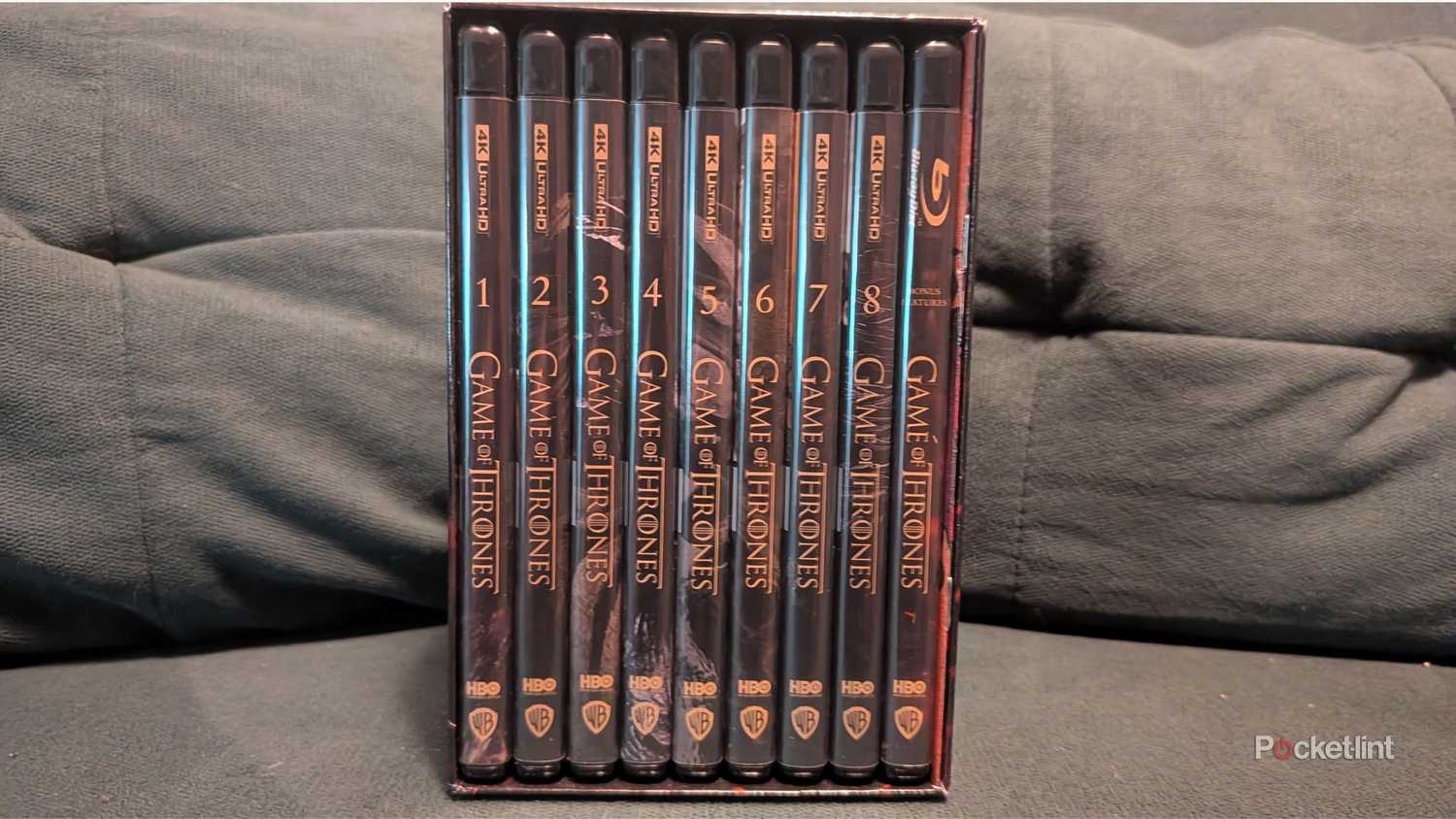 The Game of Thrones 4K box set on a couch.