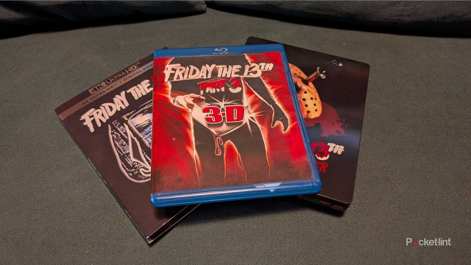 A set of Friday the 13th Blu-ray movies sitting on a loveseat.