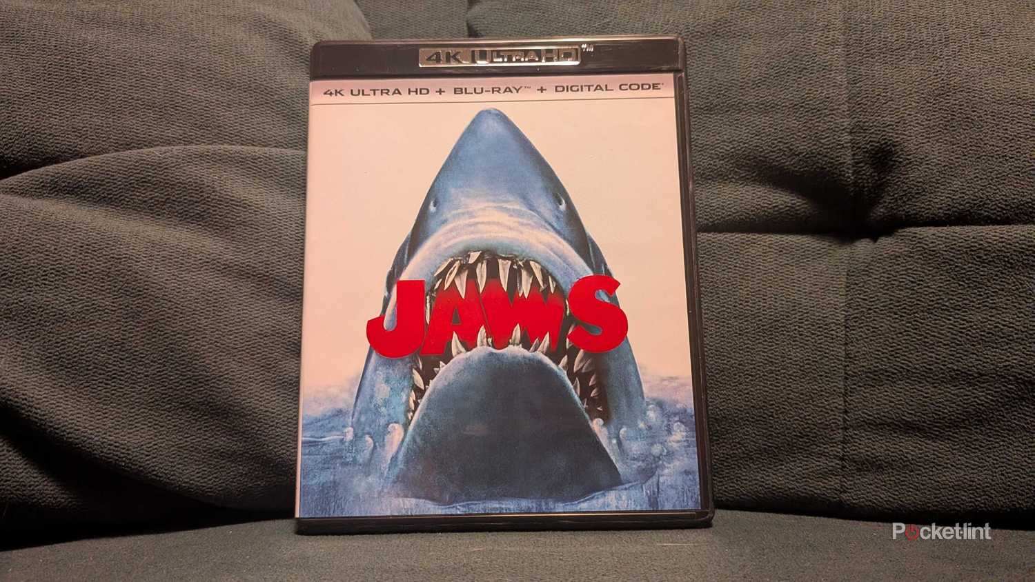 The Jaws 4K Blu-ray displayed on a couch.