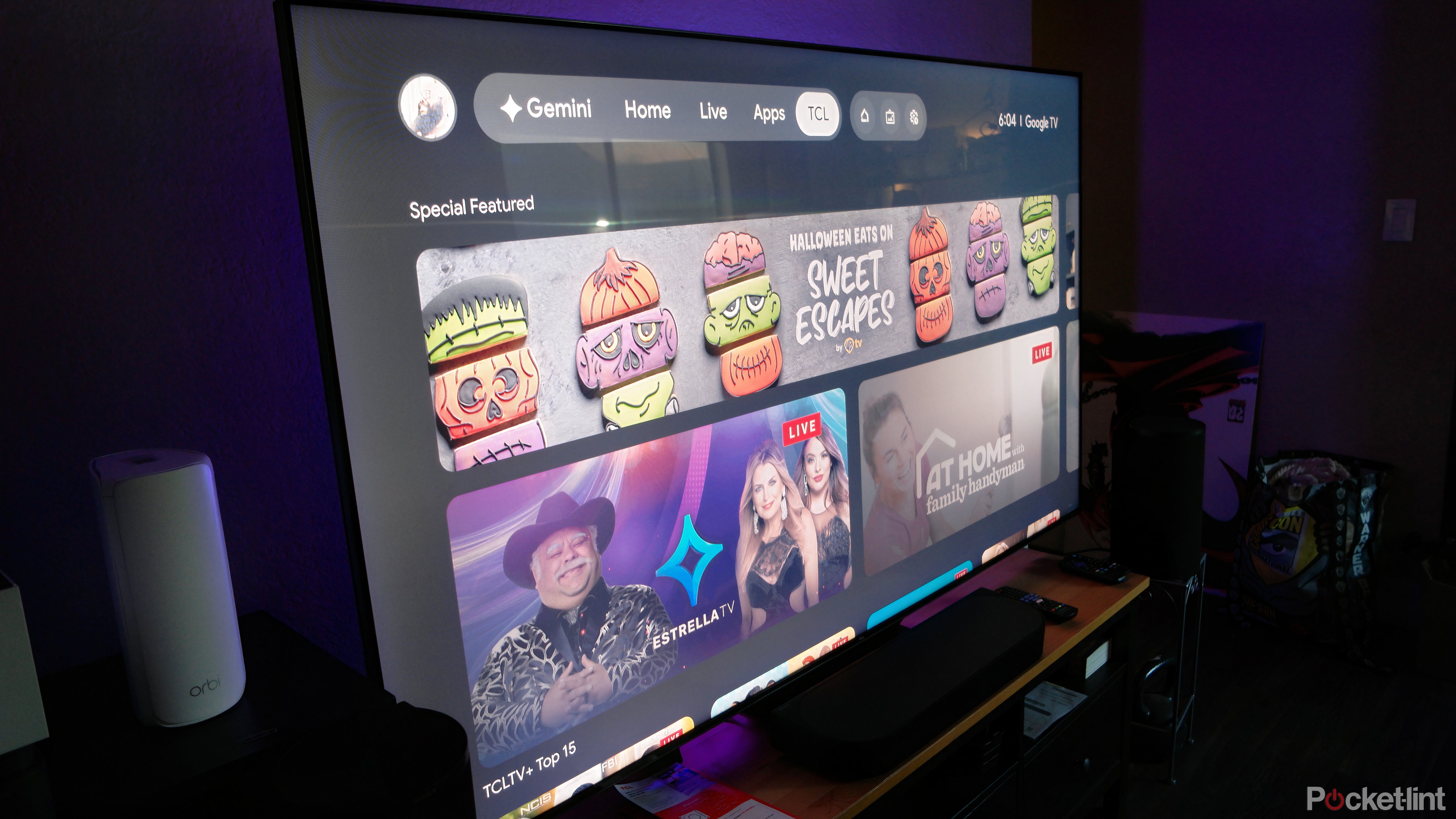 TCL 75QM7L Google TV in a dark living room with purple accent lighting